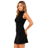 niffty black ribbed knit two-piece set with a sleeveless mock-neck asymmetric top and matching mini skirt on a model
