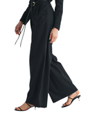 niffty black wide-leg tailored trousers in a linen-cotton blend with a gold-accented tie belt, side view