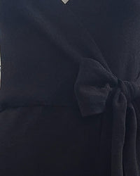 niffty black knit midi dress featuring a flattering wrap silhouette with a self-tie waist belt and V-neckline