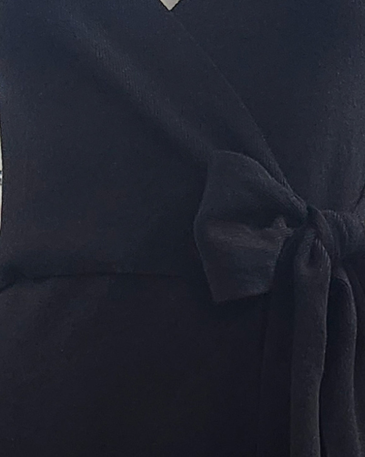 niffty black knit midi dress featuring a flattering wrap silhouette with a self-tie waist belt and V-neckline