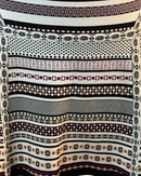 niffty Diane von Furstenberg A-line skirt featuring a black, white, and purple geometric stripe knit pattern