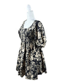 niffty Free People Dear Delilah mini dress in black and cream floral print with smocked bust and puff sleeves