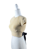 niffty Lovers and Friends nude cropped knit top with short sleeves and a contrasting black open-back tie closure