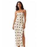 niffty strapless maxi dress in cream with black polka dots, featuring a side slit and flowing polyester silhouette