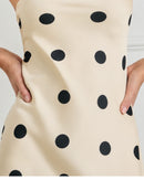 niffty strapless maxi dress in cream with black polka dots, featuring a smooth polyester fabric