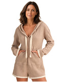 niffty taupe waffle knit hooded romper with long sleeves, contrasting drawstring, and trim on a smiling model