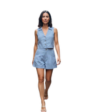 A woman modeling a light blue sleeveless collared romper with button-front detail and matching shorts, shown against a plain white background.